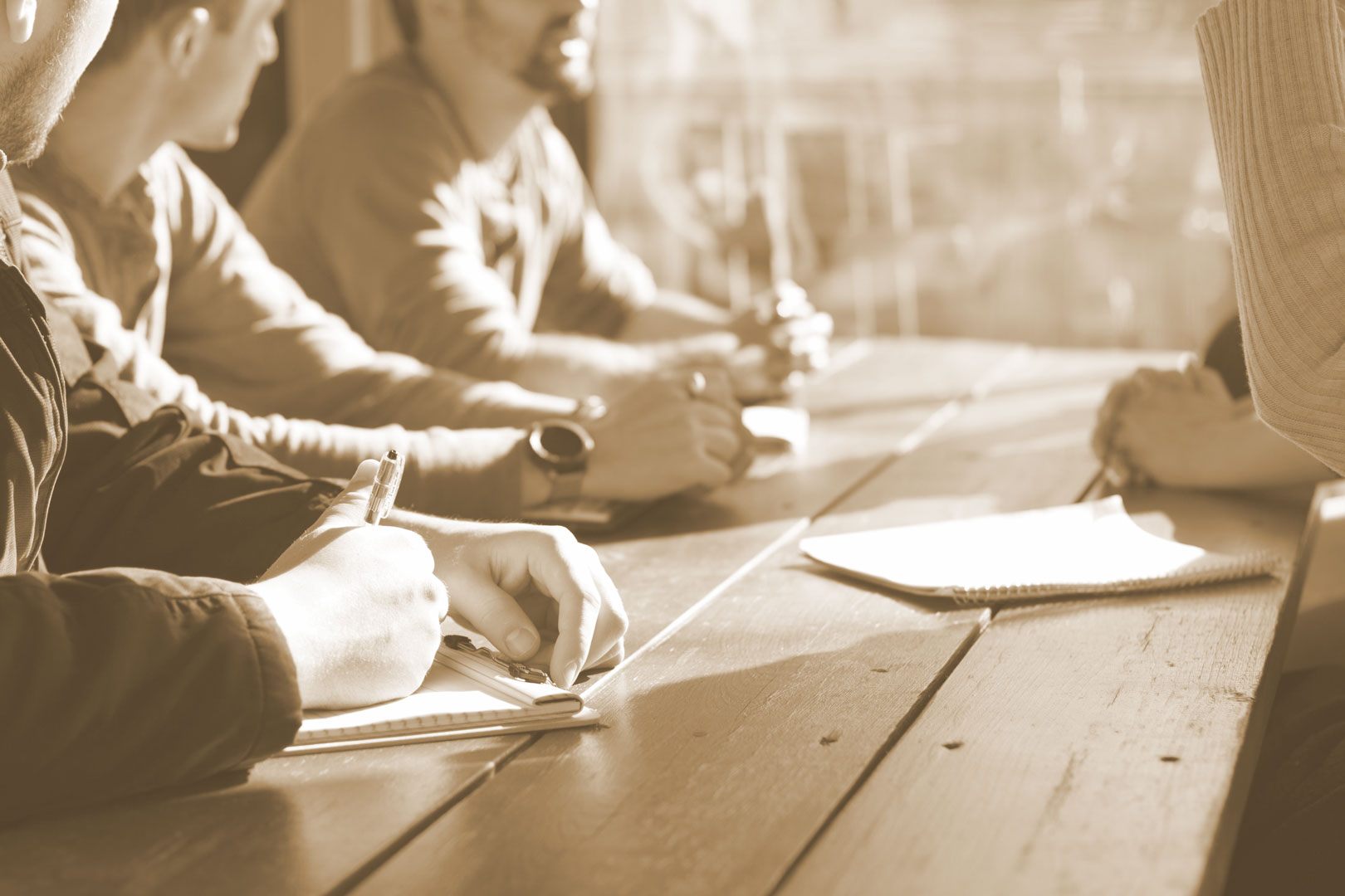 People at a desk consulting about typefaces and typography.